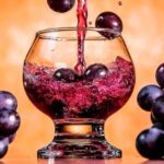uvachado, bebida amazónica afrodisiaca sirviéndose en vaso con la misma fruta, uva negras